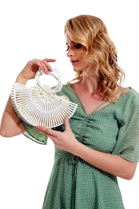 Detailed side view of white semi-circular bamboo slat bag with clear acrylic ring handles