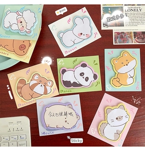 Macro shot of cute cartoon animal sticky notes set with colorful cards on desk
