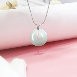 Detail of S925 sterling silver pinch bail on a white round donut pendant necklace