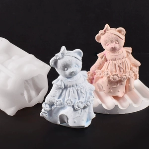 Detail of DIY silicone mold showing 3D teddy bear shaped candles in pink and blue finish