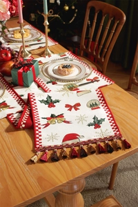 Detailed view of Christmas table runner with embroidered bells and festive tassels