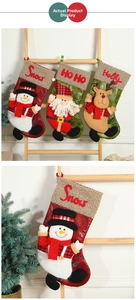Detail of Christmas stockings with plush Santa, Reindeer and Snowman 3D characters