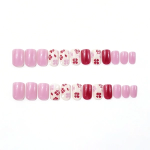 Short square glossy press-on nails with purple solids and delicate floral patterns