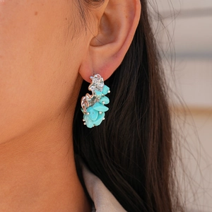 Retro C-shape earrings featuring irregular turquoise stones with a silver needle post