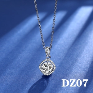 Close-up of sparkling 2-carat round cut zircon pendant with silver halo on blue silk