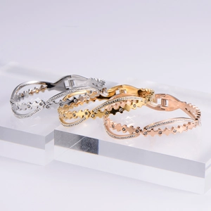 Three-piece set of clover charm metal bangles in silver gold and rose gold finishes
