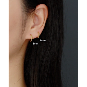 Minimalist gold S925 sterling silver hoop earrings in 7mm and 8mm sizes worn on ear