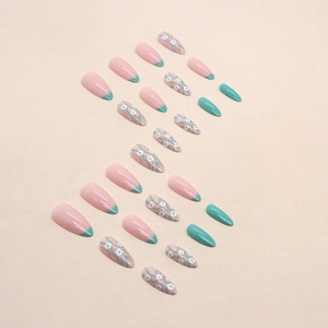 Almond shaped press-on nails in light green and nude with white daisy flower patterns