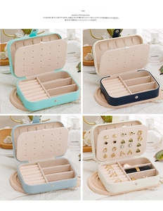 Internal view of portable travel jewelry box showing ring slots and earring panel