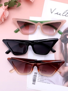 Detail view of stylish narrow cat-eye sunglasses in pink, green, and tortoiseshell colors