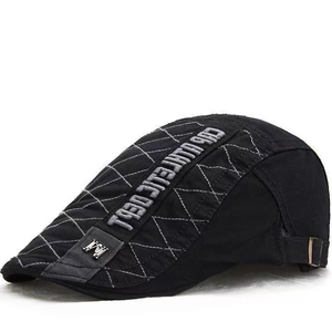 Detail of vintage black beret hat with white diamond stitching and athletic embroidery
