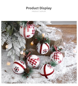 Close-up of white Christmas foam balls with red snowflakes and rustic pine decorations