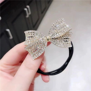 Sparkling crystal butterfly hair tie with black elastic band and golden metal base