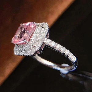 Macro shot of luxury emerald-cut pink zircon ring with double halo pavé diamonds
