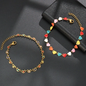 Gold chain bracelet featuring colorful enamel heart and moon charms for women