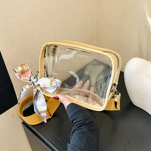 Yellow transparent PVC jelly crossbody bag with wide strap and floral silk scarf detail