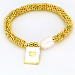 Close-up of golden beaded bracelet with white baroque pearl and heart pendant