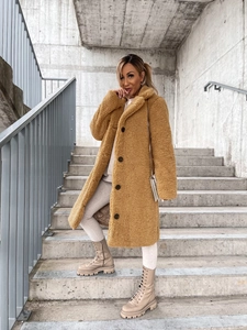 Close-up of camel teddy coat showing lapel collar, buttons and plush texture detail