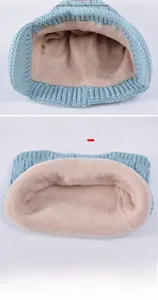 Detail of baby winter neck warmer showing thick cream fleece lining and light blue knit