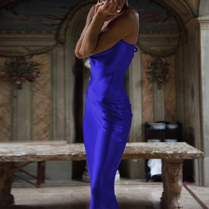 Detail of royal blue satin evening gown featuring glossy fabric and elegant backless design