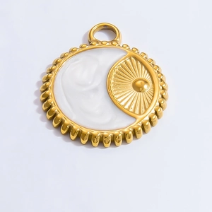 Detailed view of a golden circular pendant featuring a sunburst motif and white inlay