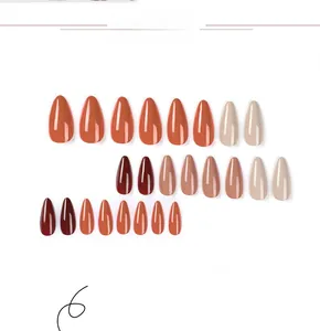 Macro detail of 24pcs almond press-on nails in glossy earth tones and burgundy finish