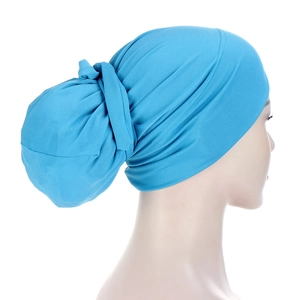 Detail view of the pleats and back knot design on a bright blue turban headwear