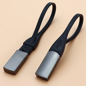 Minimalist grey metal keychain and bottle opener with black silicone loop by Aurelien Barbry