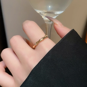 Macro detail of gold plated bamboo style ring featuring fine zircon inlay and metallic luster