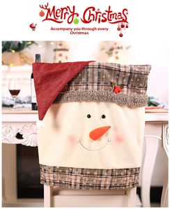 Detail of plush snowman chair cover with 3D carrot nose for Christmas dining decor