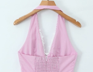 Detail of pink and white striped halter top featuring white lace trim and elastic back
