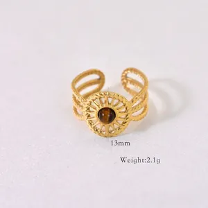 Detail view of gold bohemian stainless steel ring with round tiger eye stone inlay
