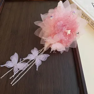 Pink mesh flower shark hair claw clip with rhinestone tassels and butterfly accents