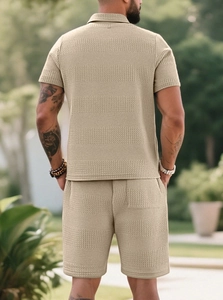Detail of khaki knit polo set back view showing textured jacquard fabric and relaxed fit