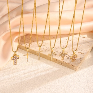 Set of six gold cross pendant necklaces with zircon crystals and twist chain detail