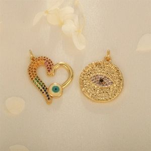 Gold Evil Eye heart and hammered round pendants with colorful zirconia on soft fabric