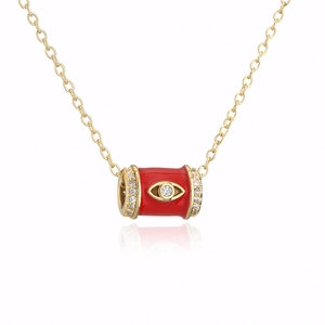 Detailed view of red enamel evil eye pendant with 18K gold plating and zircon inlay