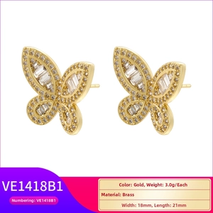 Macro detail of gold-plated brass butterfly wing earrings inlaid with clear zircon crystals