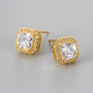 Macro detail of square zircon stud earrings with sparkling halo micro-pave setting
