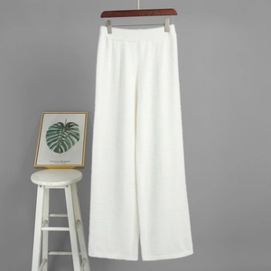 Detail of white high-waist knitted wide-leg pants with soft plush texture for winter