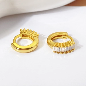 Detail shot of gold-plated hoop earrings with rectangular-cut clear cubic zirconia crystals