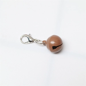 Close-up of brown metal pet bell with silver lobster clasp on white background