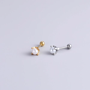 Macro detail of crown setting pearl stud earrings with steel screw ball backings