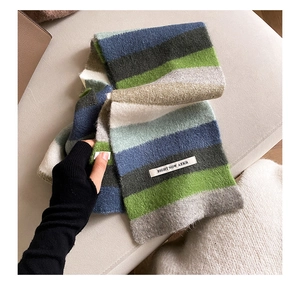 Detail shot of a soft rainbow striped mohair scarf with a white BIGHT NOW AZKR woven label