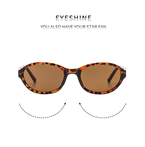 Detailed view of retro narrow oval sunglasses with brown tortoise shell frames and tan lenses