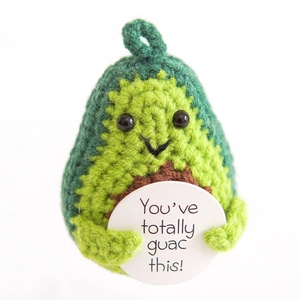 Detail of handmade crochet avocado toy with card saying You've totally guac this!