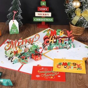 3D pop-up Christmas cards featuring Santa and penguins on a festive wooden surface