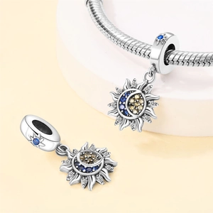 Macro detail of silver celestial charm with blue yellow zircons for DIY jewelry