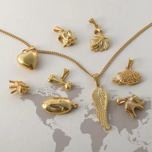 24k gold plated vintage pendants with heart, animal shapes on a world map background