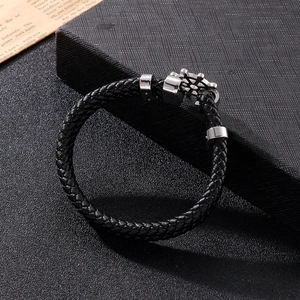 Detail of nautical black leather woven bracelet with silver stainless steel rudder clasp